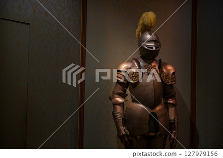 Armor and helmet medieval knight suit in dark castle room Armor and helmet medieval knight suit in dark castle room 127979156