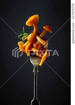 Pickled honey mushrooms garnished with rosemary. 127979278