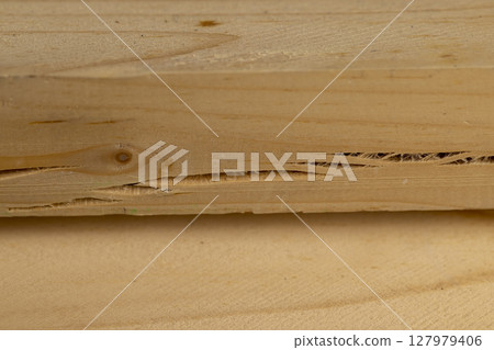 an old wooden board with cracks, a pine wood board cracked during operation 127979406