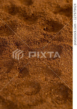 brown ground coffee , uneven ground coffee bean background for making a high-quality and aromatic coffee drink 127979424