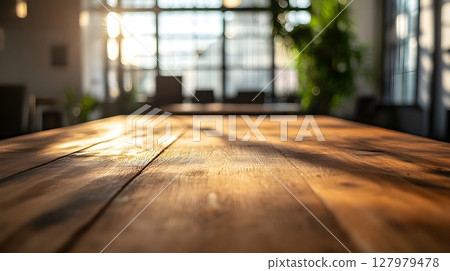 warm wooden table in sunlit office 127979478