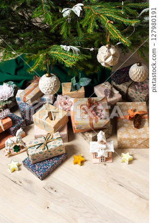 A cozy Christmas scene with elegant natural-toned gift boxes placed under a Christmas tree, lit with festive lights, evoking peace and seasonal joy A cozy Christmas scene with elegant natural-toned gift boxes placed under a Christmas tree, lit with festive lights, evoking peace and seasonal joy 127980191