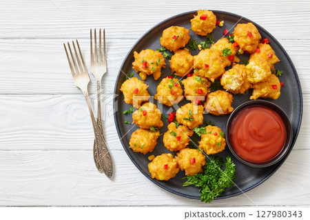 corn nuggets on a plate with tomato sauce corn nuggets on a plate with tomato sauce 127980343