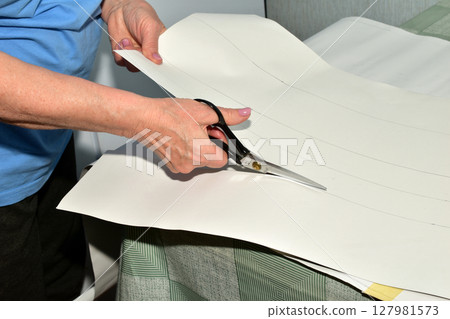 The cutter works at the table with paper. 127981573