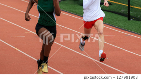 Runners Competing on a Track During a School Athletics Event Runners Competing on a Track During a School Athletics Event 127981908