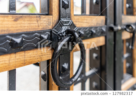 Selective focus, texture of a metal old lattice fence against the blue sky, fence lattice, lattice background, cell. High quality photo Selective focus, texture of a metal old lattice fence against the blue sky, fence lattice, lattice background, cell. High quality photo 127982317