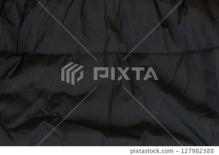 Textured black fabric showcasing soft, cozy warmth for winter fashion essentials Textured black fabric showcasing soft, cozy warmth for winter fashion essentials 127982388