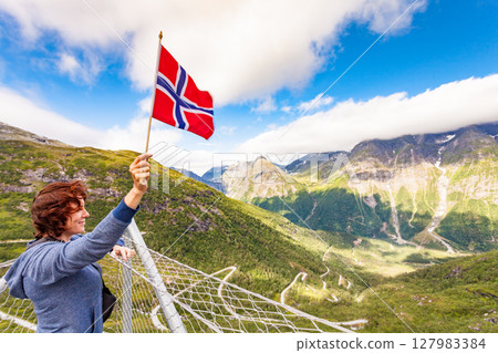 Tourist on Utsikten viewpoint, Norway Tourist on Utsikten viewpoint, Norway 127983384
