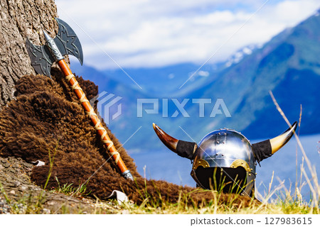 Viking helmet on fjord shore, Norway 127983615