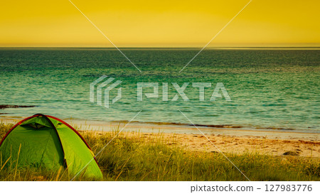 Seascape with tent on beach, Lofoten Norway Seascape with tent on beach, Lofoten Norway 127983776