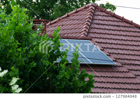Installing a Solar Cell on a Roof. Solar panels on roof. Historic farm house with modern solar panels on roof and wall. High quality photo Installing a Solar Cell on a Roof. Solar panels on roof. Historic farm house with modern solar panels on roof and wall. High quality photo 127984048