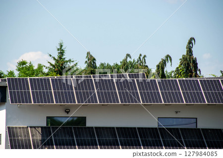 House roof with photovoltaic modules. Historic farm house with modern solar panels on roof and wall High quality photo House roof with photovoltaic modules. Historic farm house with modern solar panels on roof and wall High quality photo 127984085