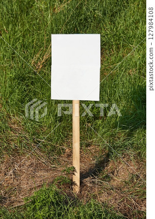 Empty sign on a land, green grass Empty sign on a land, green grass 127984108