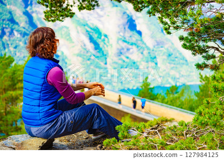 Tourist enjoying mountains fjord view, Norway 127984125
