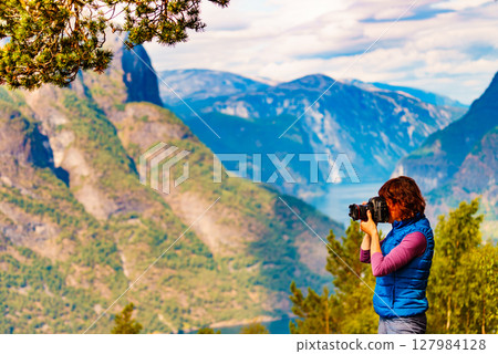 Tourist on nature take travel picture, Norway Tourist on nature take travel picture, Norway 127984128