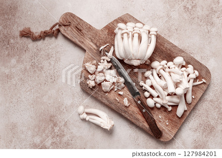 Freshly sliced Shimizhi mushrooms, on a wooden chopping board, ready to cook, close-up, no people, 127984201