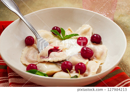 Traditional dumplings with cherries and yogurt, close-up, no people, 127984213