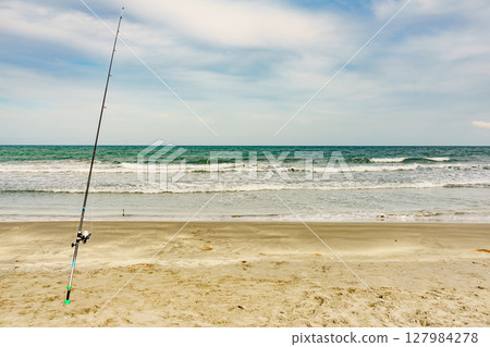 Fishing rod at the shore of sea. 127984278
