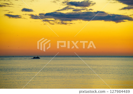Fishing boat on sea at sunrise Fishing boat on sea at sunrise 127984489