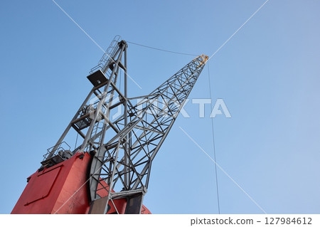 Old dock freight crane in a cargo port Old dock freight crane in a cargo port 127984612