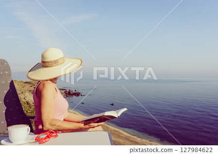 Woman on sea read book, relaxing 127984622