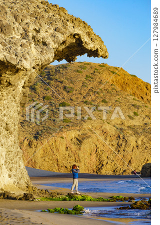 People walk on Monsul beach, Park Cabo de Gata, Spain 127984689