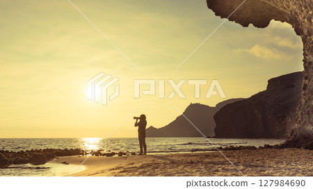 Woman with camera on Monsul beach, Spain 127984690