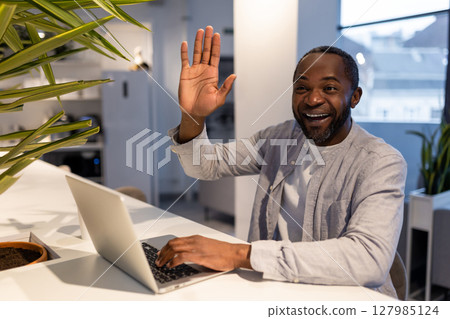 African american man at the laptop in a coworking area African american man at the laptop in a coworking area 127985124