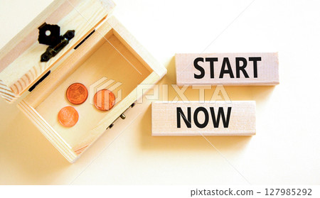 Start now symbol. Concept words Start now on beautiful wooden block. Beautiful white table white background. Wooden chest with coins. Business marketing, motivational start now concept. Copy space. 127985292