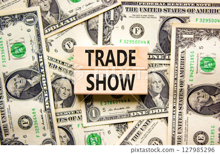 Trade show symbol. Wooden blocks with concept words Trade show on beautiful background from dollar bills. Business economic financial trade show concept. Copy space. Trade show symbol. Wooden blocks with concept words Trade show on beautiful background from dollar bills. Business economic financial trade show concept. Copy space. 127985296