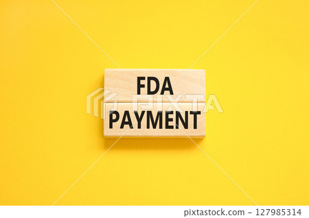 FDA Food and Drug Administration payment symbol. Concept words FDA payment on beautiful wooden blocks. Beautiful yellow table yellow background. Business FDA payment concept. Copy space. 127985314