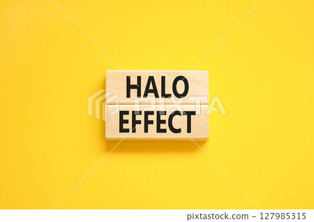 Halo effect and psychological symbol. Concept words Halo effect on beautiful wooden block. Beautiful yellow table yellow background. Business psychological and Halo effect concept. Copy space. 127985315