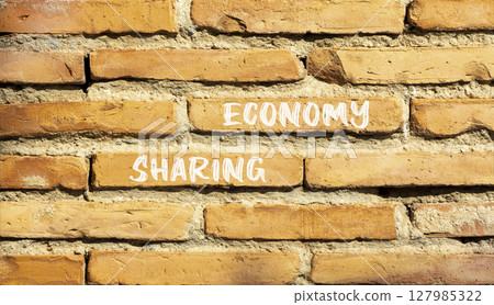 Sharing economy symbol. Concept words Sharing economy on beautiful brown brick wall. Beautiful brown brick wall background. Business sharing economy concept. Copy space. Sharing economy symbol. Concept words Sharing economy on beautiful brown brick wall. Beautiful brown brick wall background. Business sharing economy concept. Copy space. 127985322