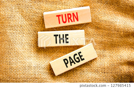 Turn the page symbol. Concept words Turn the page on beautiful wooden block. Beautiful canvas table canvas background. Business motivational lifestyle turn the page concept. Copy space. 127985415