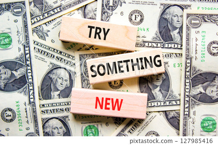 Try something new symbol. Concept words Try something new on beautiful block. Dollar bills. Beautiful background from dollar bills. Business motivational lifestyle try something new concept Copy space Try something new symbol. Concept words Try something new on beautiful block. Dollar bills. Beautiful background from dollar bills. Business motivational lifestyle try something new concept Copy space 127985416