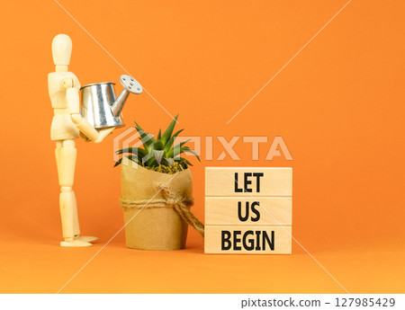 Let us begin symbol. Concept words Let us begin on beautiful wooden blocks. Beautiful orange background. Businessman model. Business motivational let us begin concept. Copy space. Let us begin symbol. Concept words Let us begin on beautiful wooden blocks. Beautiful orange background. Businessman model. Business motivational let us begin concept. Copy space. 127985429