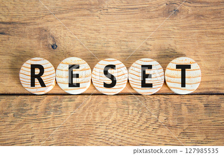 Reset symbol. Concept word Reset on beautiful wooden circles. Beautiful wooden table wooden background. Business lifestyle reset concept. Copy space. Reset symbol. Concept word Reset on beautiful wooden circles. Beautiful wooden table wooden background. Business lifestyle reset concept. Copy space. 127985535