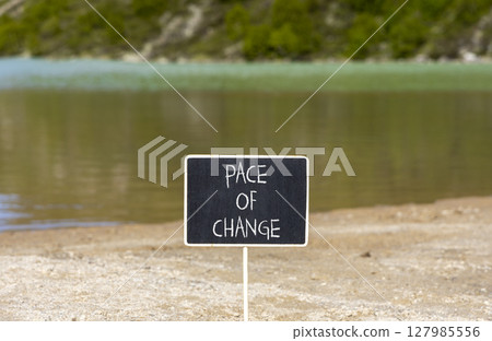 Pace of change symbol. Concept words Pace of change on beautiful black yellow blackboard. Beautiful mountain lake background. Business pace of change concept. Copy space. Pace of change symbol. Concept words Pace of change on beautiful black yellow blackboard. Beautiful mountain lake background. Business pace of change concept. Copy space. 127985556