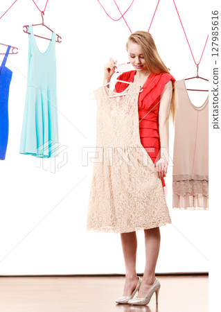 Woman in shop or wardrobe picking clothes Woman in shop or wardrobe picking clothes 127985616