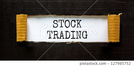 Stock trading symbol. Concept words Stock trading on beautiful white paper. Beautiful black paper background. Business stock trading concept. Copy space. Stock trading symbol. Concept words Stock trading on beautiful white paper. Beautiful black paper background. Business stock trading concept. Copy space. 127985752