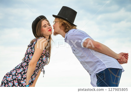 Couple flirting kissing on date against sky background 127985805