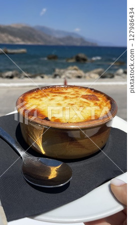 Freshly Baked Moussaka by the Sea with Scenic View 127986434