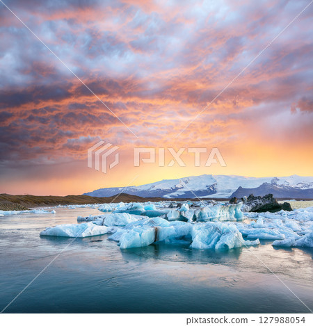 Ramarkable landscape with floating icebergs in Jokulsarlon glacier lagoon at sunset. Ramarkable landscape with floating icebergs in Jokulsarlon glacier lagoon at sunset. 127988054