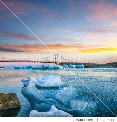 Impressive landscape with floating icebergs in Jokulsarlon glacier lagoon at sunset. Impressive landscape with floating icebergs in Jokulsarlon glacier lagoon at sunset. 127988055