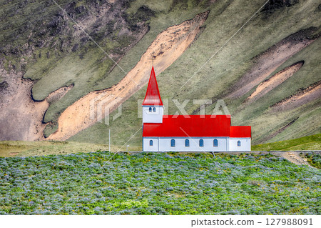 Impressive view of Vikurkirkja christian church in front of mouintain Impressive view of Vikurkirkja christian church in front of mouintain 127988091