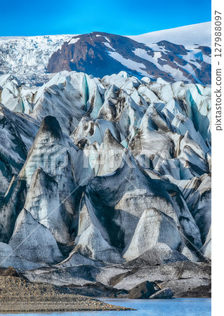 Impressive view of Skaftafellsjokull glacier tongue and volcanic mountains around on South Iceland. Impressive view of Skaftafellsjokull glacier tongue and volcanic mountains around on South Iceland. 127988097