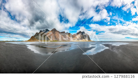 Impressive sunny day and gorgeous reflection of Vestrahorn mountaine on Stokksnes cape in Iceland. Impressive sunny day and gorgeous reflection of Vestrahorn mountaine on Stokksnes cape in Iceland. 127988116