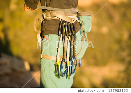 A young girl is engaged in active sports, rock climbing and mountaineering. 127988163