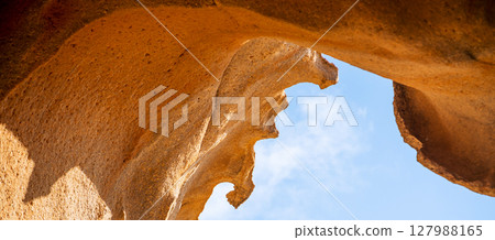 A rock, desert sandy formations, a natural arch Arco de las Penitas in the daylight. A rock, desert sandy formations, a natural arch Arco de las Penitas in the daylight. 127988165