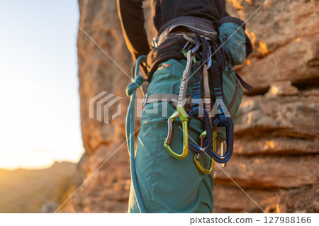 A young girl is engaged in active sports, rock climbing and mountaineering.  127988166